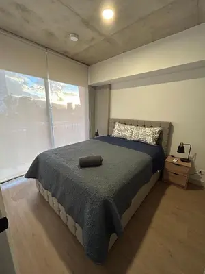 a bedroom with a large bed and a large window at Chill Lodge Babylon Tower 506 in San José
