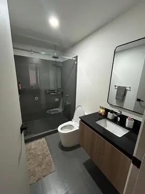 a bathroom with a toilet and a sink and a mirror at Chill Lodge Babylon Tower 506 in San José