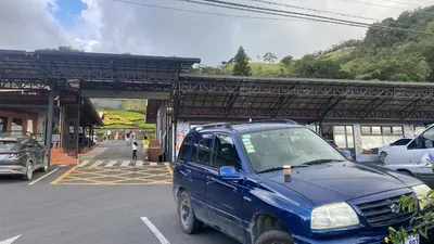 a blue pick up truck parked in a parking lot at Poasito Room in Fraijanes