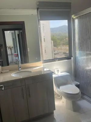a bathroom with a toilet and a sink and a window at Jacobay condominio 3303 in Jacó