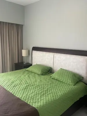 a green bed with two green pillows on it at Jacobay condominio 3303 in Jacó