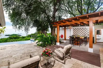an outdoor patio with a table and chairs and a dining room at Casa de Los Suenos in Potrero
