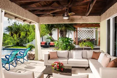a patio with a couch and chairs and a pool at Casa de Los Suenos in Potrero