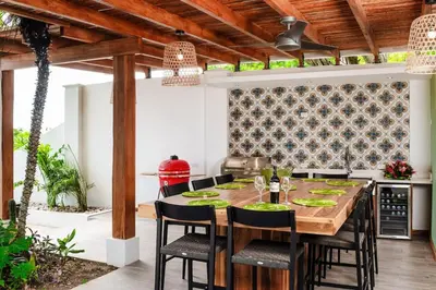 an outdoor dining room with a wooden table and chairs at Casa de Los Suenos in Potrero