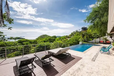 a patio with chairs and a swimming pool on a house at Casa de Los Suenos in Potrero