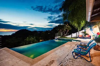 a pool with a table and a chair next to it at Casa de Los Suenos in Potrero
