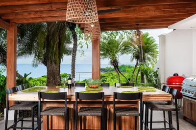 a dining room with a table and chairs with a view at Casa de Los Suenos in Potrero