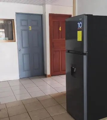 a black refrigerator in a room with two doors at Complete house for 6 people in Chiles