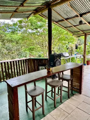 a wooden table and stools on a deck with a grill at Complete house for 6 people in Chiles