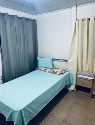 a small bedroom with a bed and a chair at Complete house for 6 people in Chiles
