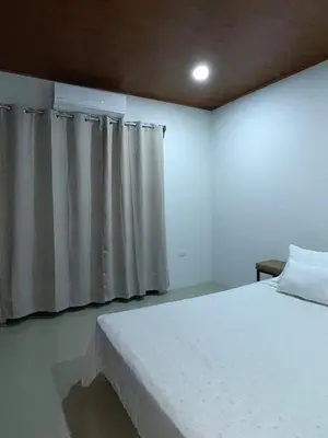 a bedroom with a white bed and curtains at SJO - Casa Taccari in Grecia