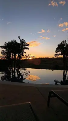 a sunset over a lake with trees in the background at SJO - Casa Taccari in Grecia