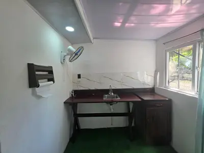 a small bathroom with a sink and a window at WAVESCRhouse1 in Parrita