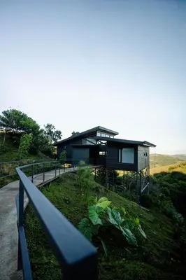 a house on top of a hill with a fence at BìBO Horizon House in Monteverde Costa Rica