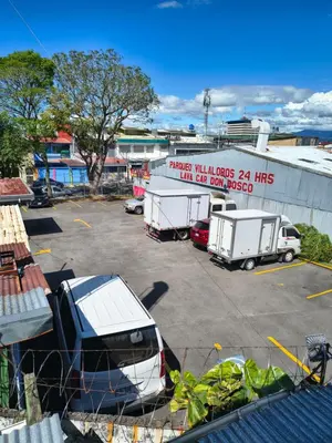 a group of trucks parked in a parking lot at Vilma Friendly Guesthouse - RC in San José