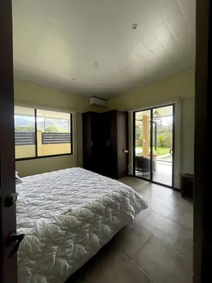 a bedroom with a large bed and sliding glass doors at Casa Blue in Brasilito