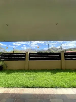 a wall with benches in a field of grass at Casa Blue in Brasilito