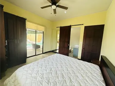 a bedroom with a bed and a ceiling fan at Casa Blue in Brasilito