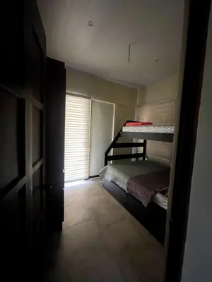 a bedroom with two bunk beds and a window at Casa Blue in Brasilito