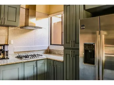 a kitchen with a refrigerator and a stove top oven at Casa Blue in Brasilito