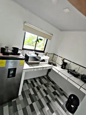 a small kitchen with a sink and a window at The Chicken House in El Castillo de La Fortuna