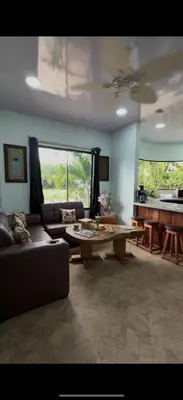 a living room with a couch and a table at Casa Tres Diamantes 6pax, Pool, AC, WIFI in Parrita