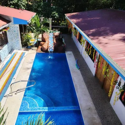 a pool in a backyard with a water slide at Casa Tres Diamantes 6pax, Pool, AC, WIFI in Parrita