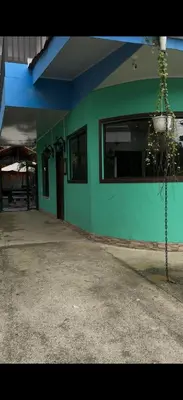 a building with a green and blue wall at Casa Tres Diamantes 6pax, Pool, AC, WIFI in Parrita