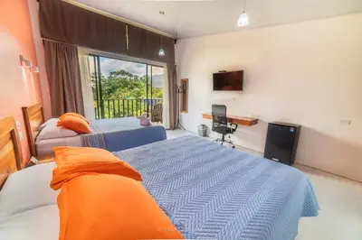 a bedroom with two beds and a window at Hotel Secreto La Fortuna in Fortuna