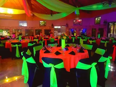 a banquet hall with red and green tables and chairs at Hotel Cibeles Resort in Heredia