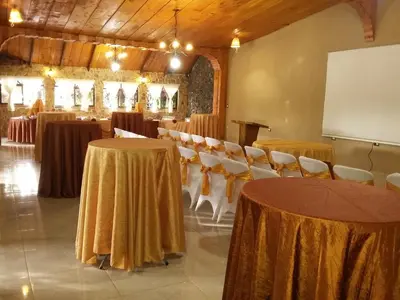 a conference room with tables and chairs and a whiteboard at Hotel Cibeles Resort in Heredia
