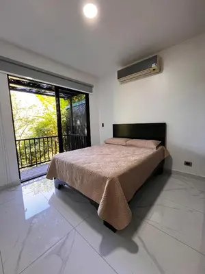 a bedroom with a bed and a large window at Hospedaje El Lago in Coronado