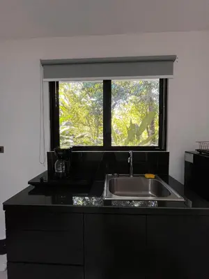 a kitchen with a sink and a window at Hospedaje El Lago in Coronado