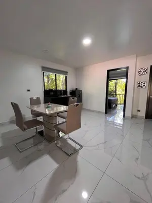 a dining room with a table and chairs on a tile floor at Hospedaje El Lago in Coronado