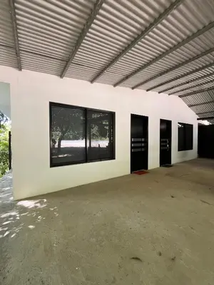 an empty building with black doors and windows at Hospedaje El Lago in Coronado