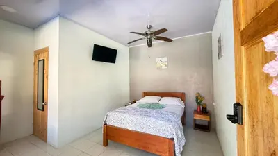 a bedroom with a bed and a ceiling fan at Tres Diamantes hotel in Parrita