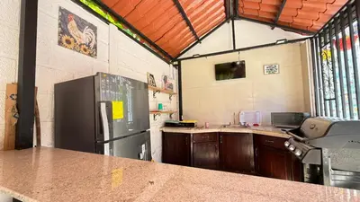 a kitchen with a refrigerator and a counter top at Tres Diamantes hotel in Parrita