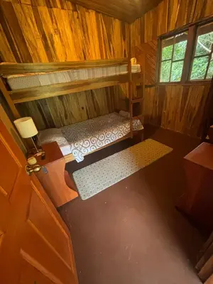 an overhead view of a bedroom in a wooden cabin at Mineral River Eco Village in Tapantí