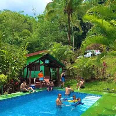 a group of people in a swimming pool at Cabañas Luz de Luna