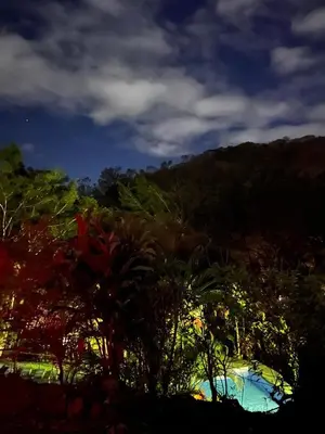 a view of a resort with trees and a mountain at Cabañas Luz de Luna