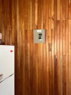 a wall with a switch on a wooden wall at Cabañas Luz de Luna