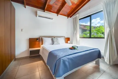 a bedroom with a bed and a large window at Villa Girasole - Villaggio 6 in Potrero