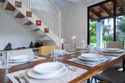 a dining room table with white plates and glasses at Villa Girasole - Villaggio 6 in Potrero