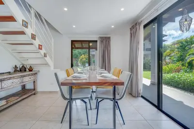 a dining room with a wooden table and chairs at Villa Girasole - Villaggio 6 in Potrero