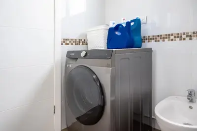 a washing machine in a bathroom next to a sink at Villa Girasole - Villaggio 6 in Potrero