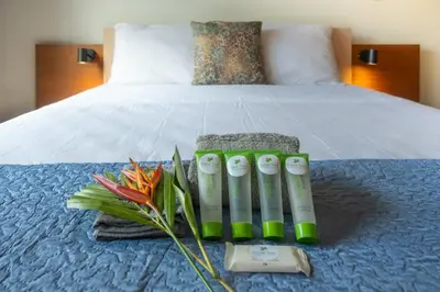 a bed with a bunch of flowers and a thermometer at Villa Girasole - Villaggio 6 in Potrero