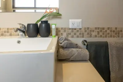 a bathroom counter with a sink and a towel at Casa Calm - Villaggio 6 in Potrero