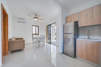 a kitchen with a stainless steel refrigerator and a table at Casa Calm - Villaggio 6 in Potrero
