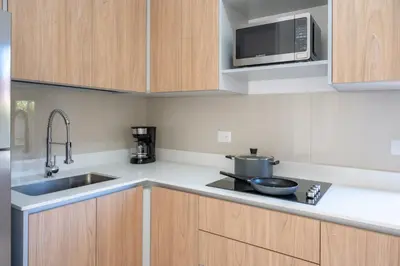 a kitchen with a sink and a microwave at Casa Calm - Villaggio 6 in Potrero