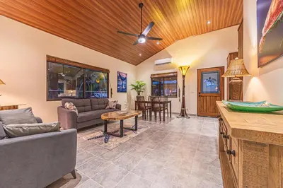 a living room with a couch and a table at Villa Tortuga- 3 Minute Walk to the Beach in Savegre